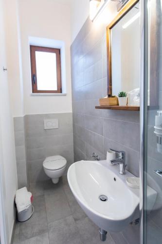 a bathroom with a sink and a toilet at Palazzo Lauritano in Agerola