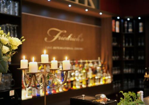 a chandelier with candles in front of a liquor store at Altstadthotel Am Theater in Cottbus