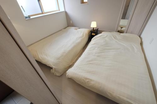 Cama o camas de una habitación en LN05 New Home in Sannomiya with Own Car Park