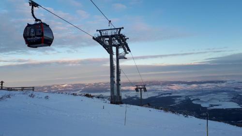 a ski lift on top of a snow covered mountain at Apartmán v Starej Lesnej s balkónom in Stará Lesná