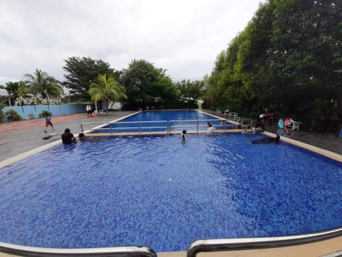 a large pool of blue water with people in it at Junikastay BLagoon Melaka in Melaka