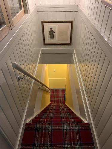 a view of a staircase with a red carpet at Logement aan de Vecht in Breukelen