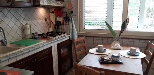 a kitchen with a table and a sink and a stove at La Melagrana in Arenella