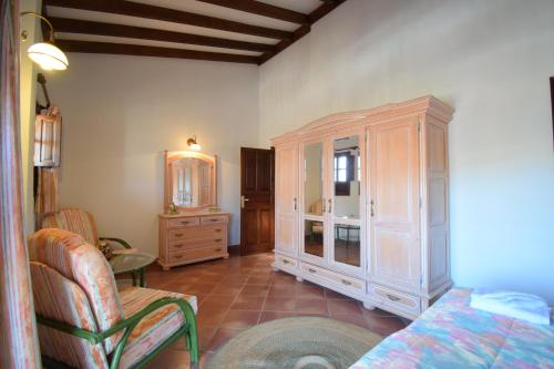 a living room with a dresser and a bedroom at Villa Altos de Santiago in Playa de Santiago