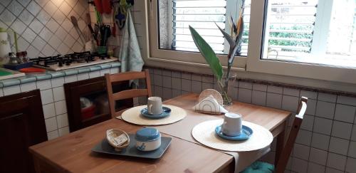 a kitchen with a wooden table with two hats on it at La Melagrana in Arenella