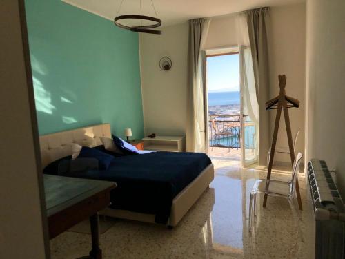 a bedroom with a bed and a window with a view at Casa sul mare in Salerno
