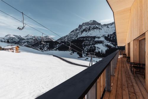 a ski lodge with a view of a mountain at Burgi's - Adults only in Lech am Arlberg