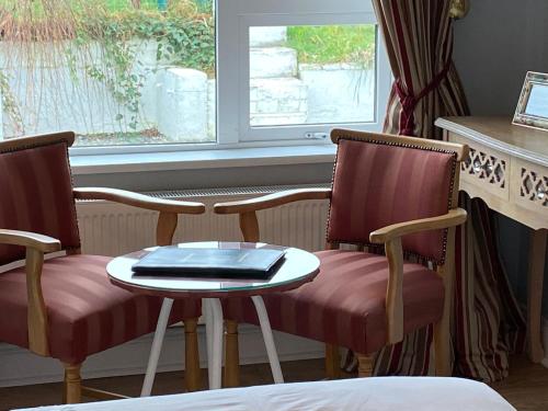 a table with a chair and a laptop on it at River Meadows B&B in Kenmare