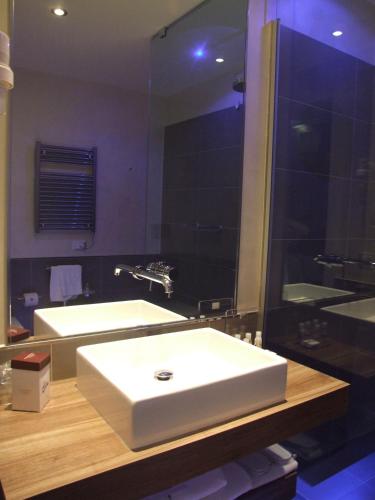 a bathroom with two white sinks and a mirror at Hotel Morgana in Rodengo Saiano