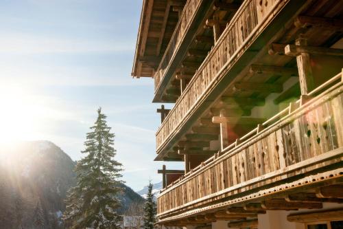 a view of the mountains from the balcony of a building at Raffl's Tyrol Hotel in Sankt Anton am Arlberg