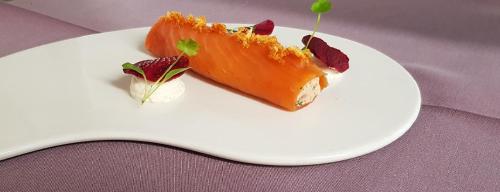 a white plate with a piece of food on it at The Rowan Tree Country Hotel in Aviemore