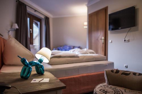 a hotel room with a bed and a table with a lamp at THOMSN Central Hotel & Appartements in Saalbach Hinterglemm