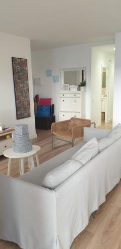 a living room with a white couch and a table at Apartment IBIZA STYLE in El Vendrell