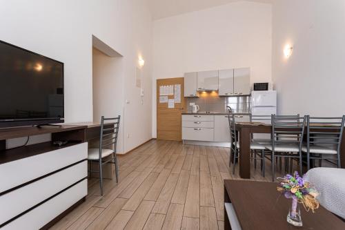 a living room with a kitchen and a dining room at Apartments Crnekovic Tomislava 8 in Baška