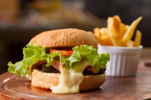 a sandwich and french fries on a plate at LEON PARK HOTEL e CONVENÇÕES - Melhor Custo Benefício in Campinas