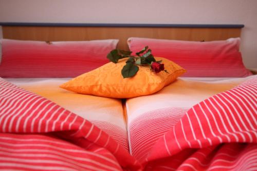 a bed with two pillows on top of it at Haus Ladner in See