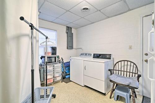 a laundry room with a washing machine and a chair at Pet-Friendly Second Row House Steps to Beach! in Holden Beach