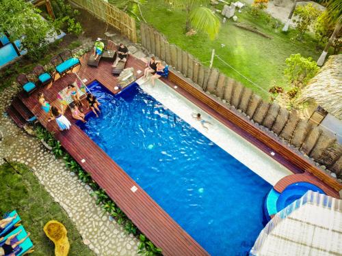 an overhead view of a swimming pool with people sitting around it at Finca Escondida in Palomino