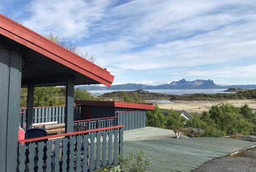 a house with a deck with a view of the ocean at Offersøy Feriesenter in Offersøy