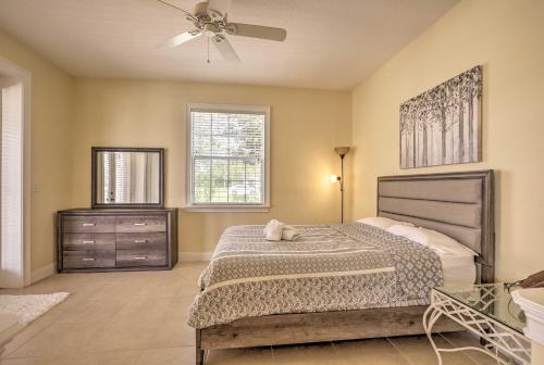 a bedroom with a bed and a ceiling fan at Luxury Palm Coast Home with Dock and Game Room! in Palm Coast