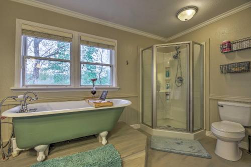 a bathroom with a green tub and a toilet at Updated Cabin on White River by Boat Landing! in Calico Rock