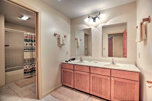 een badkamer met een wastafel, een spiegel en een douche bij House with Deck, Fire Pit - 15 Mins to Snowshoe! in Slaty Fork