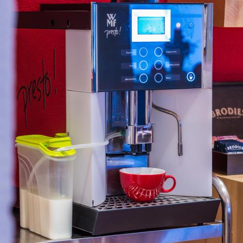 a coffee maker with a cup on a counter at Pension Steinkogel in Sankt Leonhard im Pitztal