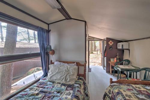 sypialnia z łóżkiem z baldachimem i oknem w obiekcie Lakefront Hartford Cabin with Canoe and Boat Ramp w mieście Hartford