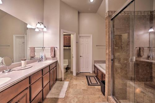 a bathroom with two sinks and a shower at Bentonville Home with Pool Table, 2 Mi to Downtown! in Bentonville