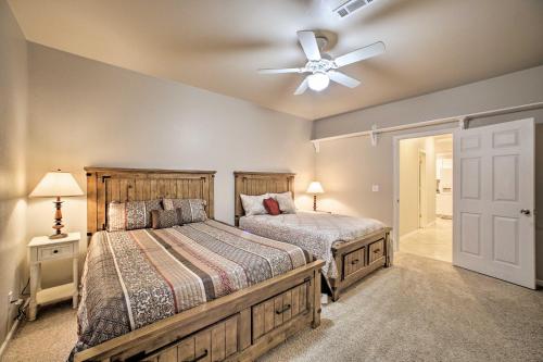 a bedroom with two beds and a ceiling fan at Bentonville Home with Pool Table, 2 Mi to Downtown! in Bentonville