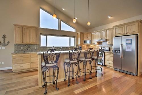 a kitchen with a counter with four bar stools at Oceanfront South Beach Home with Hot Tub and Sauna in Newport