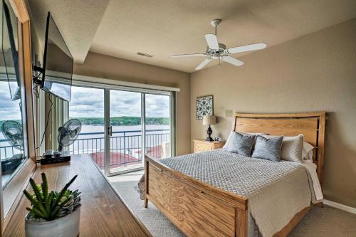 a bedroom with a bed and a large window at Waterfront Lake Ozark Condo with Deck and Pools in Lake Ozark
