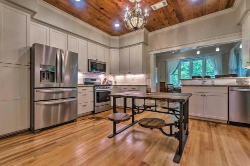 a large kitchen with a table and a refrigerator at Spacious and Updated 1920s HSNP Craftsmen Home in Hot Springs