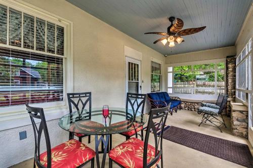 a dining room with a glass table and chairs at Spacious and Updated 1920s HSNP Craftsmen Home in Hot Springs