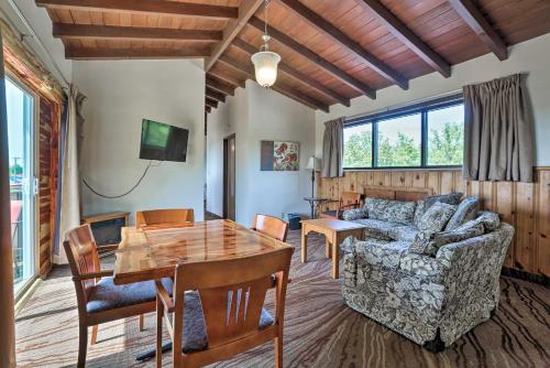 a living room with a couch and a table at Burkesville Apt with Deck, Views and Pool Access! in Burkesville