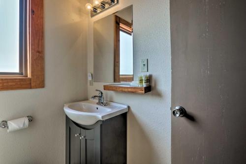 a bathroom with a sink and a mirror at Burkesville Apt with Deck, Views and Pool Access! in Burkesville