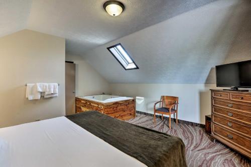 a bedroom with a bed and a tv and a tub at Burkesville Apt with Deck, Views and Pool Access! in Burkesville