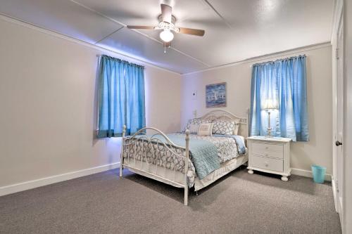 a bedroom with a bed and a ceiling fan at Gulfport Home with Deck and Grill, Walk to Beach! in Gulfport