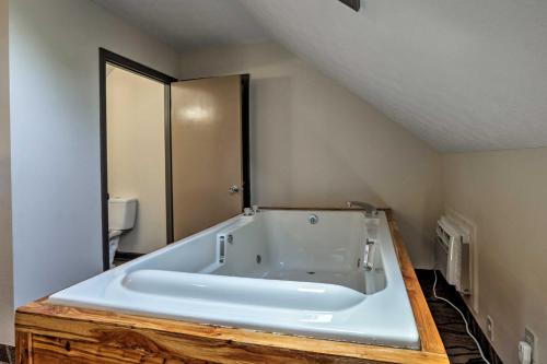 a bathroom with a bath tub in a room at Burkesville Apt with Deck, Views and Pool Access! in Burkesville