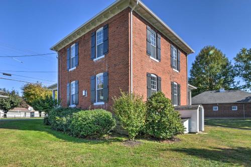 a brick house with bushes in front of it at Quaint Ligonier Family Home - 3 Miles to Idlewild! in Ligonier