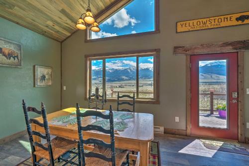 a dining room with a table and chairs and windows at Mtn-View Cabin 40 Mi to Yellowstone Ntl Park! in Livingston
