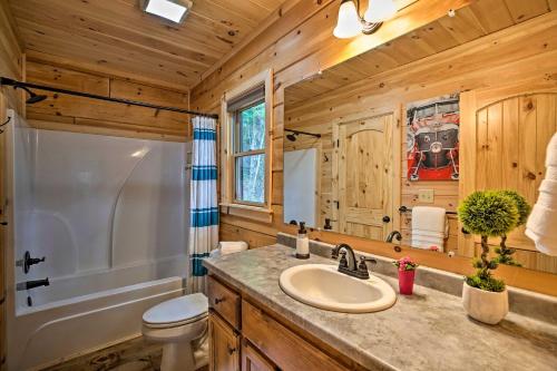 a bathroom with a sink and a toilet and a tub at A Sunset Dream - Upscale Blue Ridge Cabin! in Cherry Log