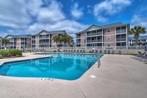 a swimming pool in front of a apartment complex at 1st-Floor Condo with Pool on Intracoastal Waterway! in Myrtle Beach