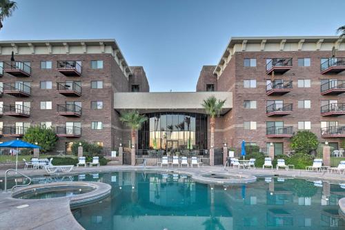 a large swimming pool in front of a building at Walk to Golf and Beach Queens Bay Resort Condo in Lake Havasu City