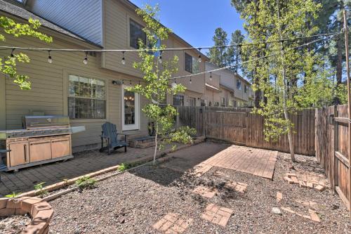 
a house with a fence and trees at Modern Flagstaff Home with BBQ, Walk Downtown! in Flagstaff
