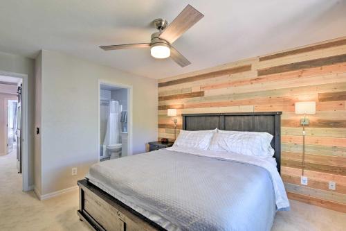 a bedroom with a wooden accent wall and a bed at Modern Flagstaff Home with BBQ Walk Downtown! in Flagstaff