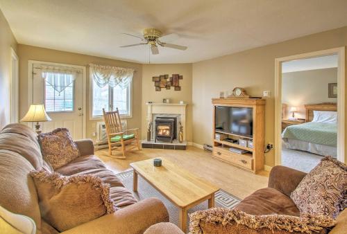 a living room with a couch and a fireplace at Lincoln Resort Condo with Pool Access - Near Hiking! in Lincoln