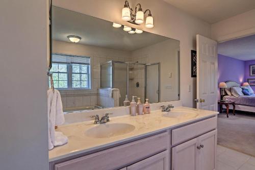 a bathroom with two sinks and a large mirror at 6 Mi to Kalahari Pocono Pines Golf Course Home! in Pocono Pines