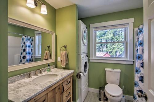 a bathroom with a sink and a toilet and a window at Lakefront Meredith Home Private Beach and Fire Pit! in Meredith