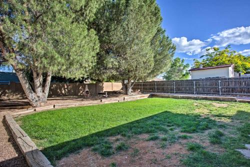a yard with grass and trees and a fence at S Cottonwood Home with Yard, 3 Mi to Main St in Cottonwood